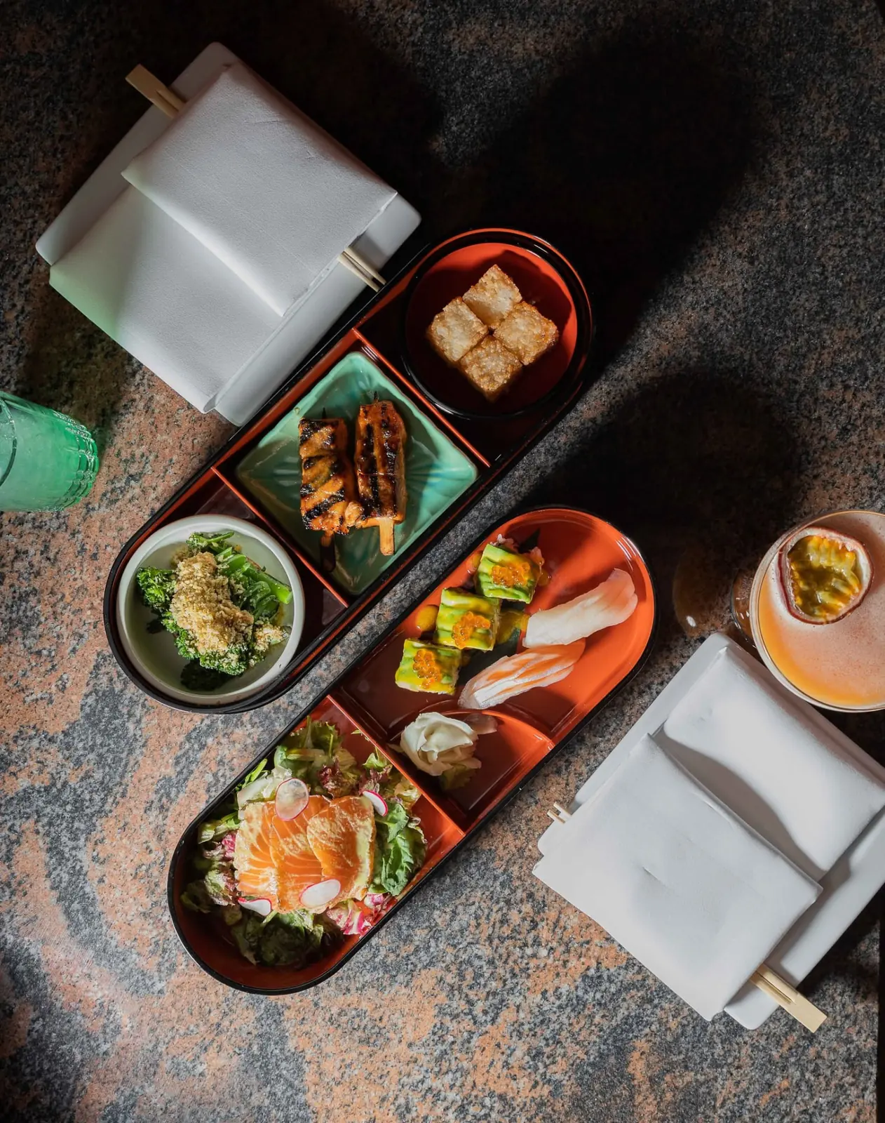 Japanese bento lunch box with salmon, grilled skewers, greens and dumplings at NAMA